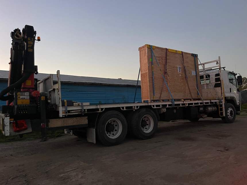 Quickcargo HIAB crane truck delivering a large timber crate