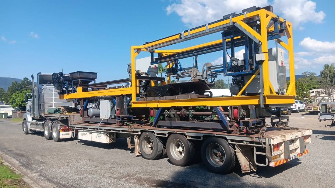 Drop-deck trailer carrying industrial machinery on a Quickcargo full truckload run