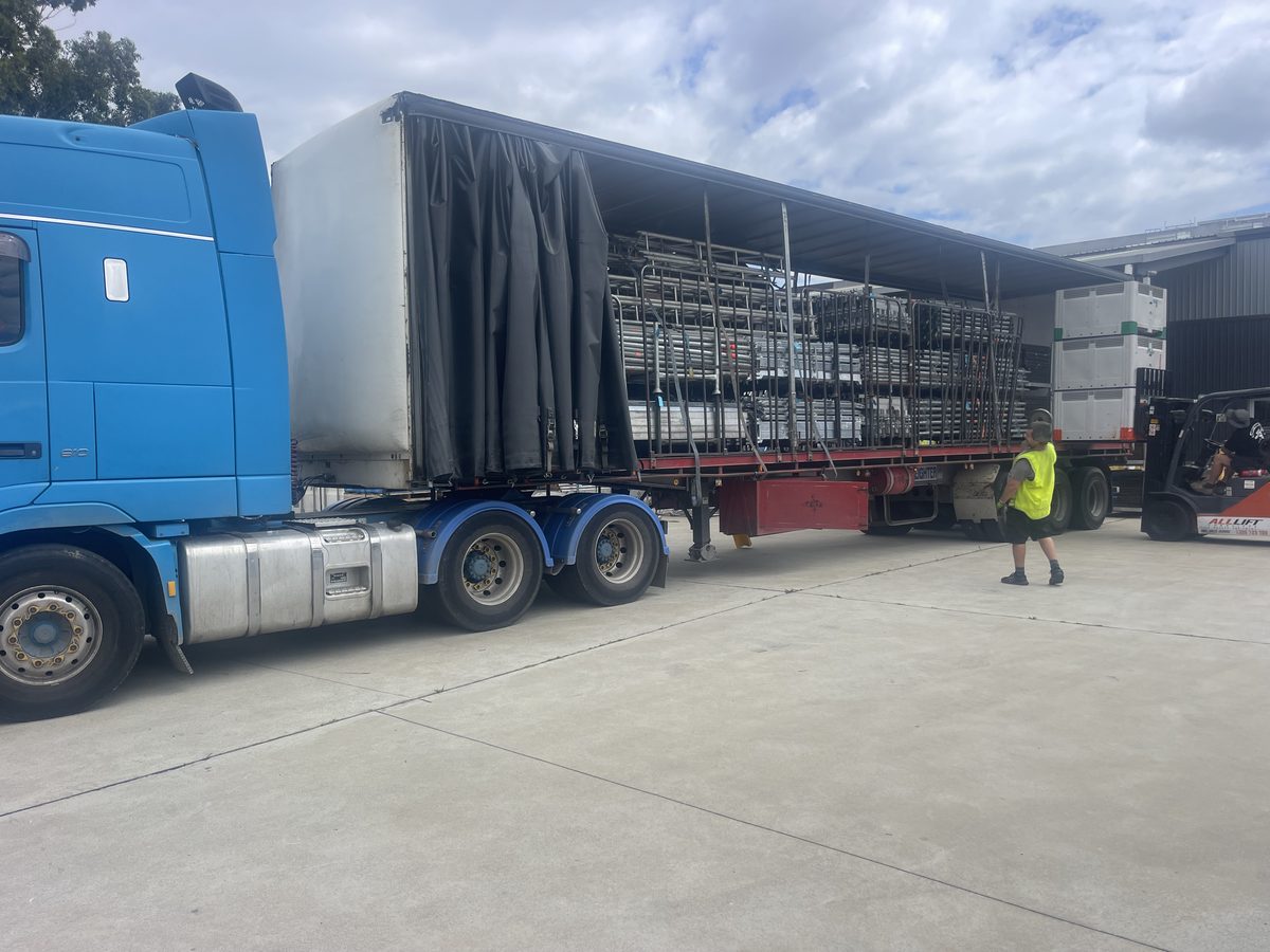 Pallet being loaded onto a Quickcargo tail-lift truck