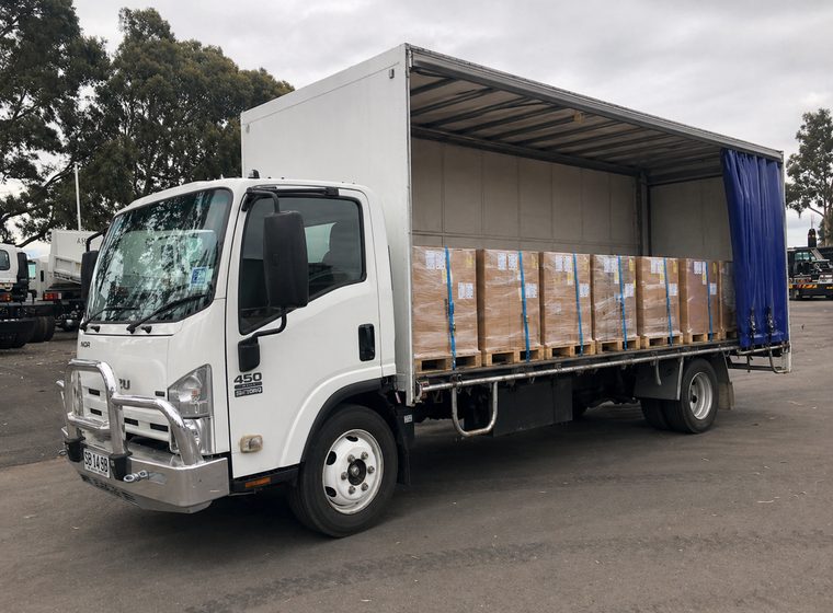 Quickcargo curtain-side truck loaded with freight